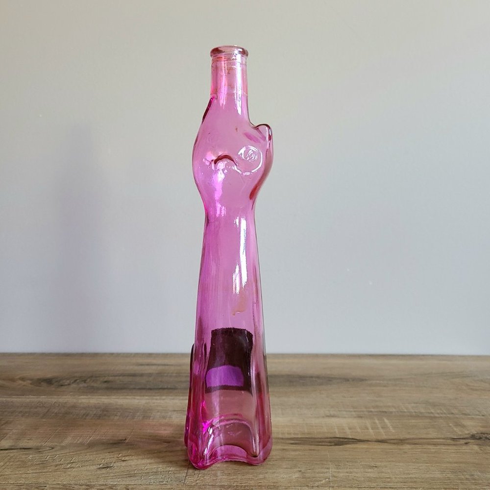 Clear pink glass cat shape wine bottle.